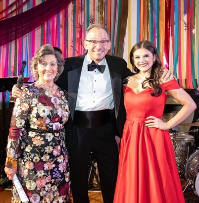 Three guests in front of drumset